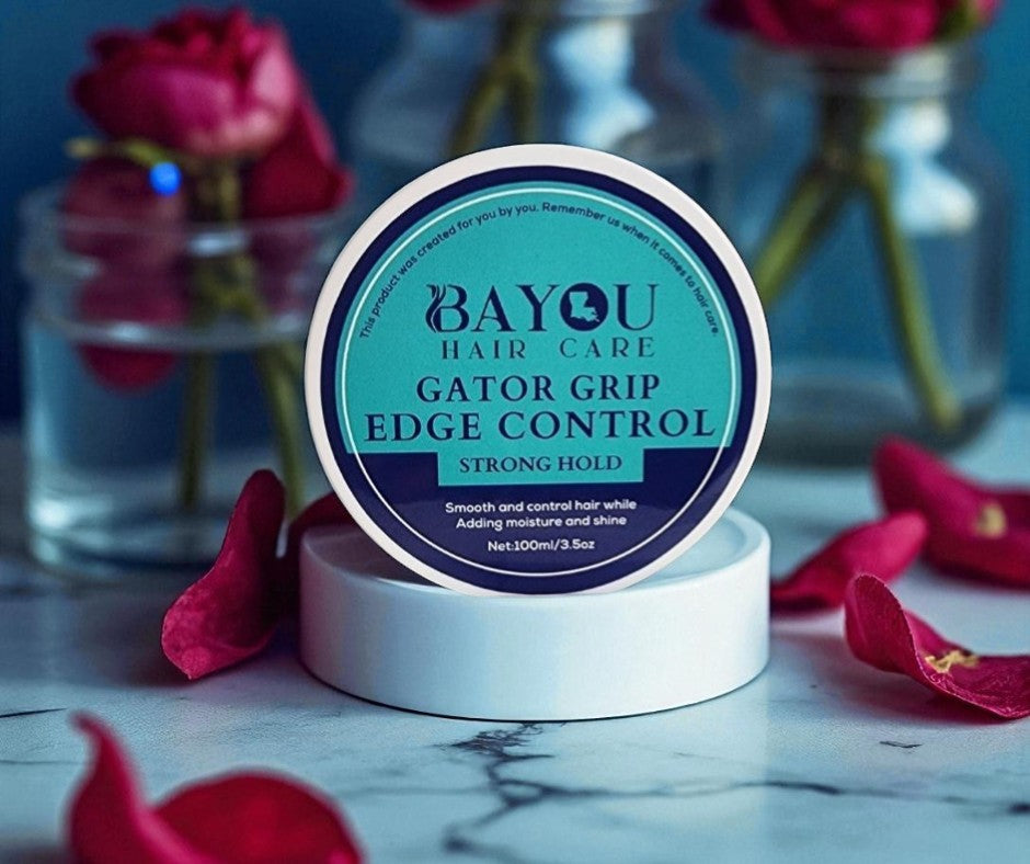 Load video: &quot;A woman with natural 4C hair applies Bayou Gator Grip Edge Control to her edges, smoothing them with a brush. The scene transitions to her smiling confidently.&quot;
